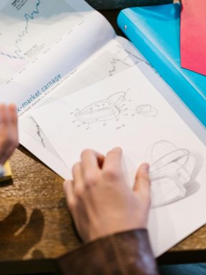 Team working on innovative design with graphs and charts in modern office setting.